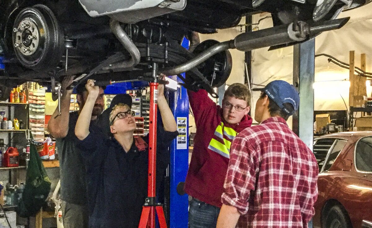 Henderson High School students Jace Huyck (left), Jake Higgenbottom and Bryan Ellis learn to work on cars at Jim's Classic Garage in Gig Harbor April 25.