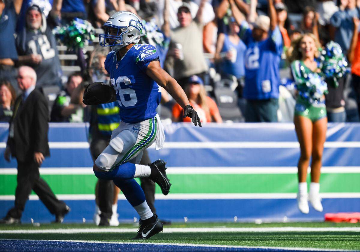 Seattle Seahawks running back Zach Charbonnet (26) runs in a passing touchdown during the fourth quarter of the game against the Denver Broncos at Lumen Field, on Sunday, Sept. 8, 2024, in Seattle, Wash.