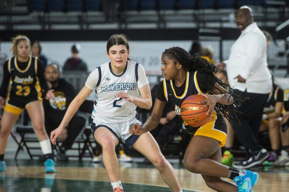 Lincoln guard Malani Warren (24) drives to the basket in the fourth quarter as Meadowdale guard Gia Powell (2) defends in the consolation round of the Class 3A girls state basketball tournament on Friday, March 3, 2023 at the Tacoma Dome in Tacoma, Wash.