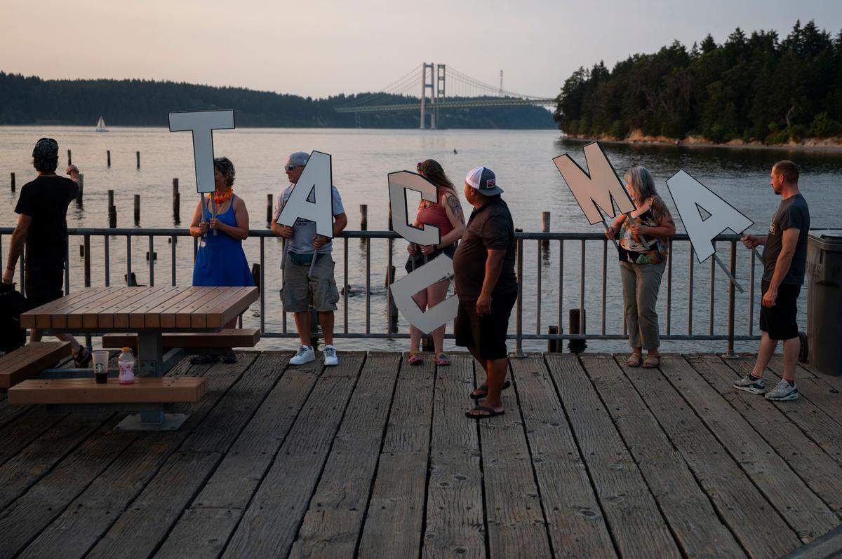 John James Nelson (left) points out to the pilings where the letters his friends and neighbors were caring that spelled out Tacoma would be attached along the shore at Titlow Beach on Friday, Aug. 9, 2024, in Tacoma, Wash.