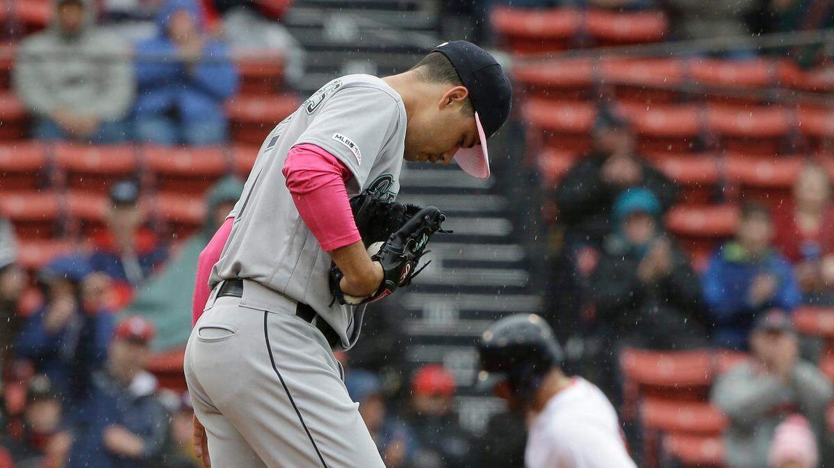 Seattle Mariners’ Marco Gonzales, left, steps on the mound as Boston Red Sox’s J.D. Martinez, right, runs the bases toward home after hitting a home run off a pitch from him in the first inning of a baseball game at Fenway Park, Sunday, May 12, 2019, in Boston.