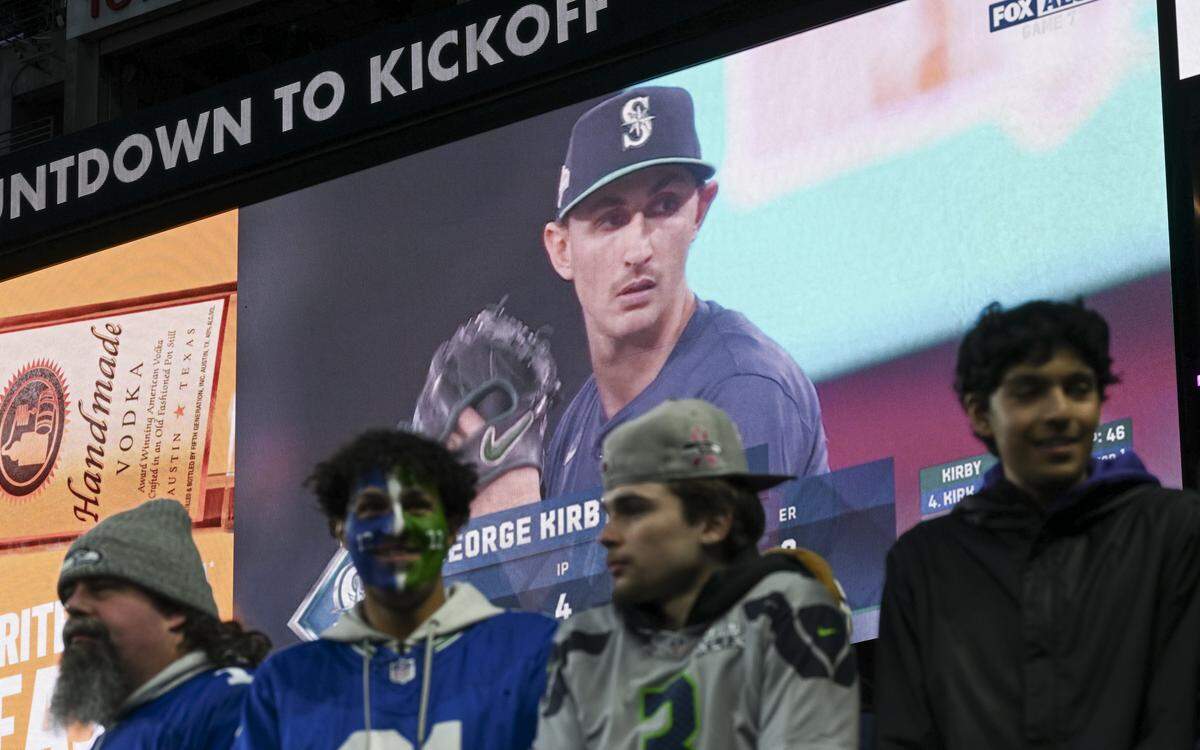 Fans wait for Seattle Seahawks as the Seattle Mariners play in the ALCS Game 7 against the Toronto Blue Jays before the game between the Seattle Seahawks and the Houston Texans at Lumen Field, on Monday, Oct. 20, 2025, in Seattle.