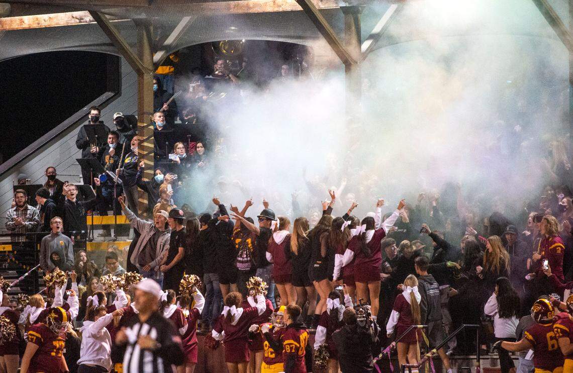 Smoke wafts over the Enumclaw fans at Pete’s Pool. The Steilacoom Sentinels football beat the Enumclaw Hornets, 14-7, in a 2A South Puget Sound League game on Friday night, Oct. 9, 2021 at Pete’s Pool in Enumclaw.