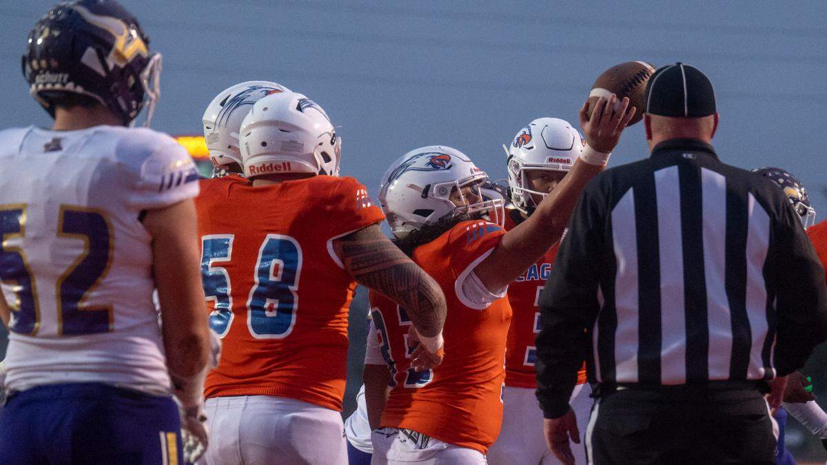 Graham Kapowsin’s Michael Toa (33) presents the ball to the referee after scoring a touchdown from the one-yard line during the second quarter of the State 4A championship game against Lake Stevens on Saturday afternoon at Mount Tahoma Stadium in Tacoma.