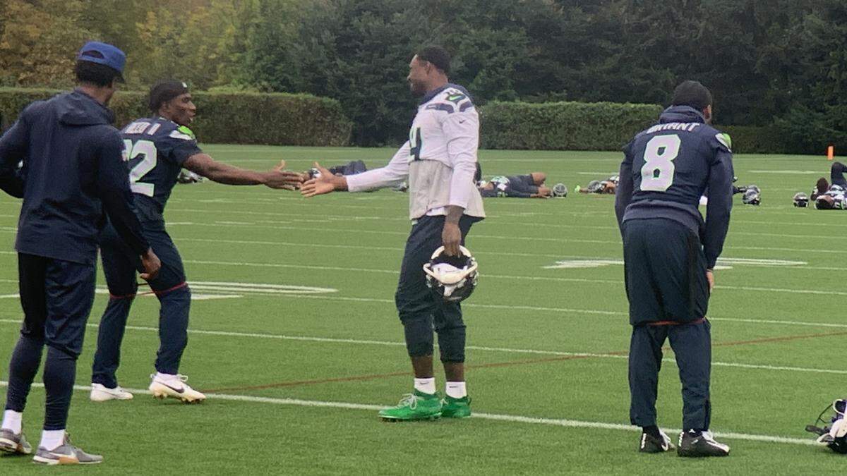 Seahawks wide receiver DK Metcalf (14) greets teammate Jerrick Reed on the second-year safety and special-teams player’s return to practice at the Virginia Mason Athletic Center Monday, Oct. 14, 2024, off the physically-unable-to-perform list.