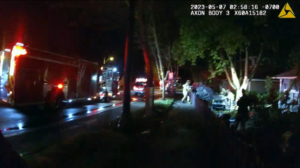 A still image from body-camera footage shows emergency responders working the scene of a fatal single-car crash that occurred Sunday, May 7, 2023 in the 3100 block of Bridgeport Way West in University Place.