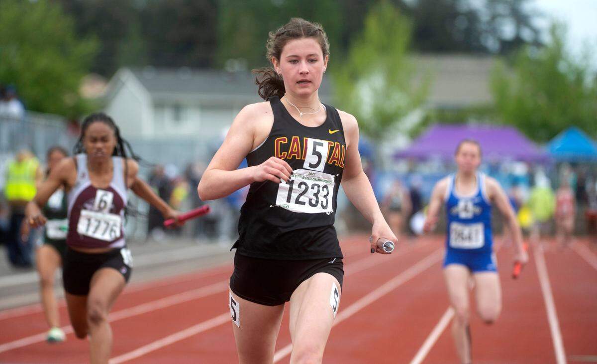 Capital’s Hana Moll anchors the 4X100 relay to victory in the 3A girls preliminaries during the second day of the WIAA State Track and Field Championships at Mount Tahoma High School in Tacoma, Washington on Friday, May 27, 2022.