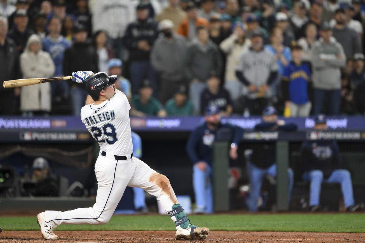 Seattle’s Cal Raleigh hits a game-tying solo home run in the eighth inning of Game 5 of the American League Championship Series against the Toronto Blue Jays on Friday, Oct. 17, 2025 at T-Mobile Park in Seattle.