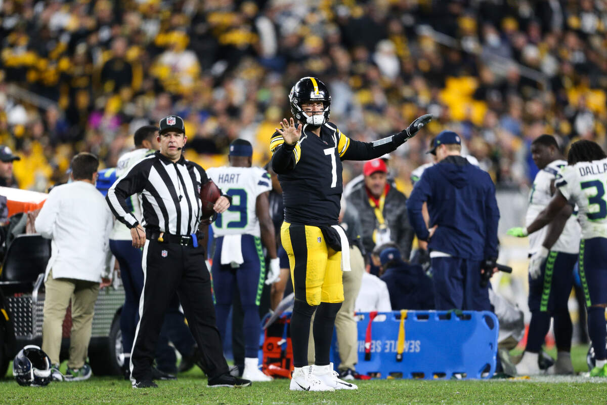 Pittsburgh Steelers quarterback Ben Roethlisberger (7) tries to quiet the crowd as fans do the wave as trainers tend to Seattle Seahawks defensive end Darrell Taylor (52) during the fourth quarter. The Seattle Seahawks played the Pittsburgh Steelers at Heinz Field in Pittsburgh, Pa., on Sunday, Oct. 17, 2021.