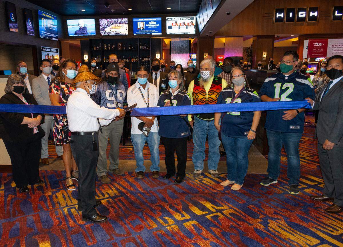 Snoqualmie Tribal Chairman Robert de los Angeles cuts the ribbon at the grand opening of the Snoqualmie Casino Sportsbook Tuesday, Sept. 7, in Snoqualmie. The Sportsbook is the first to open after sports wagering was made legal in Washington state exclusively at nine Tribes’ casinos on Sept. 1. Seven more Tribes’ sports wagering compacts are expected to be approved soon.