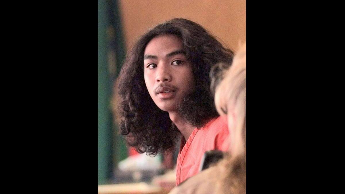 John Phet, then 16, is photographed while leaving a Pierce County Superior Court appearance, July 20, 1998. Phet later was convicted of murder and assault in a Vietnamese restaurant massacre in which five people were fatally shot and five more wounded. He was resentenced last week to a term that might allow him to one day be released from prison.