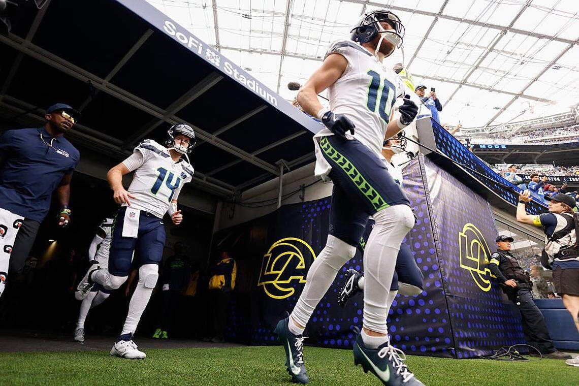 Seattle Seahawks wide receiver Cooper Kupp (10) and quarterback Sam Darnold (14) run onto the field before the game against the Los Angeles Rams at SoFi Stadium on November 16, 2025 in Inglewood, California. (Photo by Harry How/Getty Images)