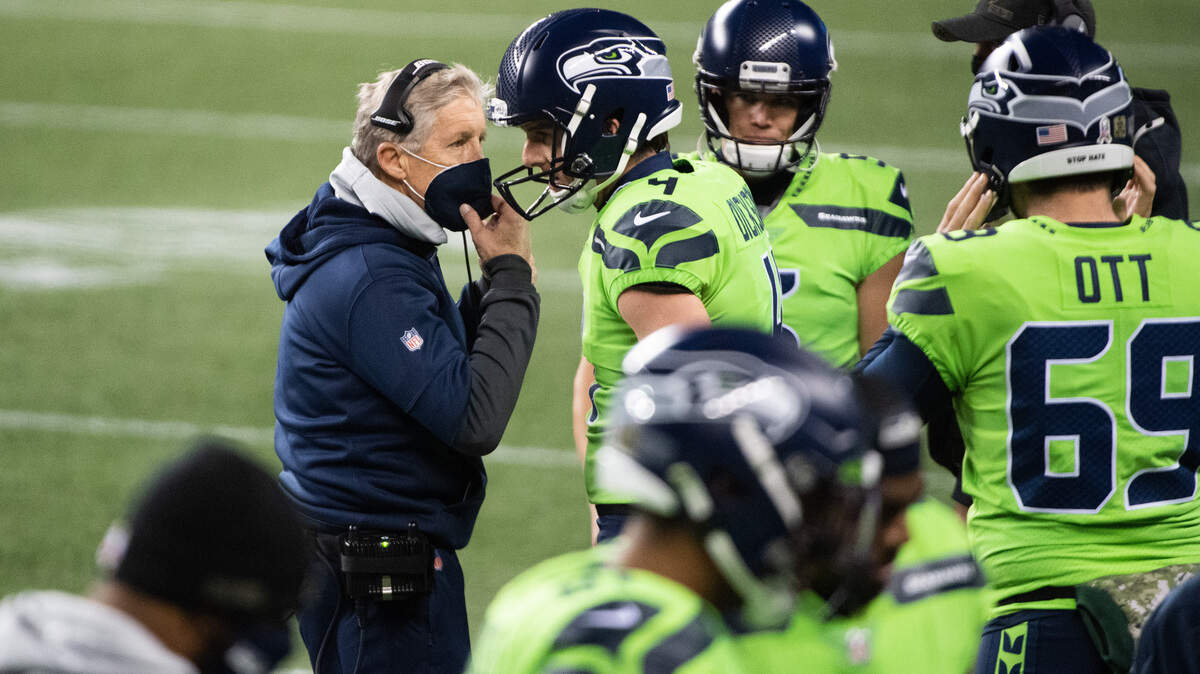 Seahawks head coach Pete Carroll talks with Seattle Seahawks punter Michael Dickson. The Seattle Seahawks played the Arizona Cardinals in a NFL football game at Lumen Field in Seattle, Wash., on Thursday, Nov. 19, 2020.