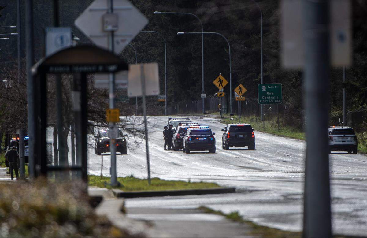 Police work the scene after two Pierce County sheriff’s deputies were shot during a SWAT operation on March 15, 2022 in Spanaway.