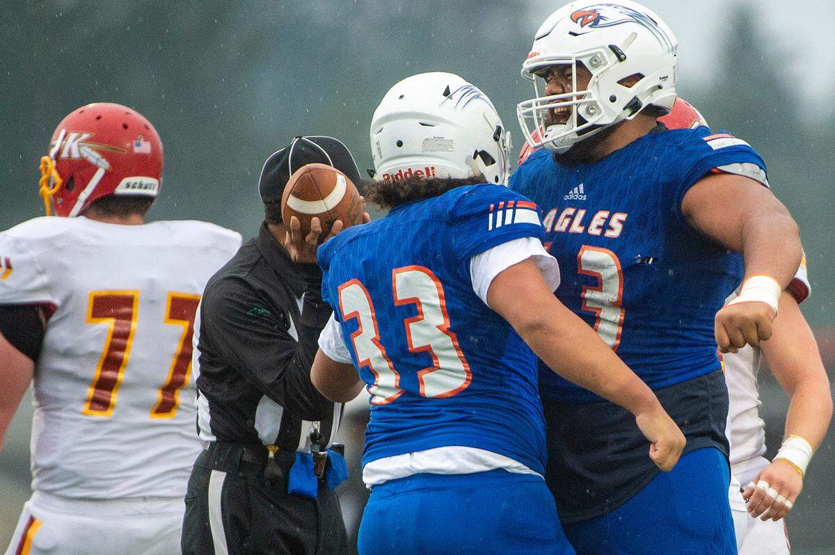 Graham Kapowsin offensive lineman Vega Ioane celebrates with running back Michael Toa (33) after Toa gained a first down in the third quarter of a State 4A semifinal game against Kamiakin on Saturday afternoon at Art Crate Field in Spanaway.