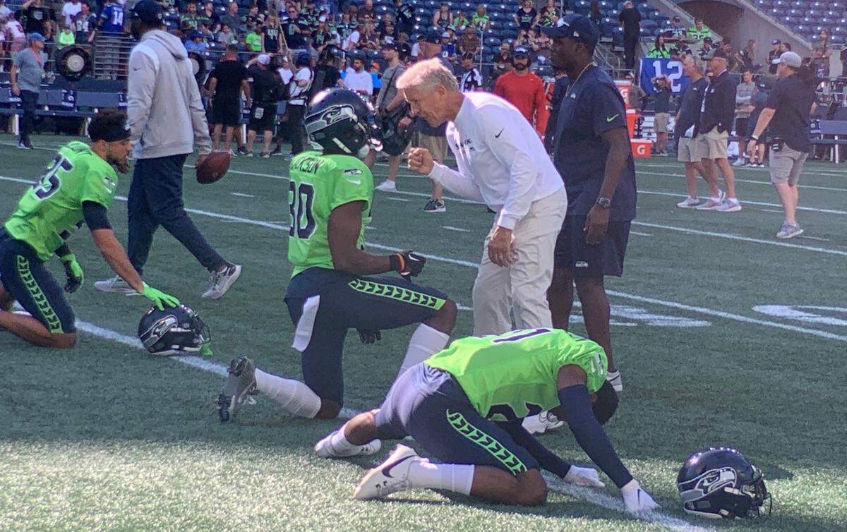 Coach Pete Carroll talks with Michael Jackson, Seattle’s current starting cornerback, before the Seahawks’ annual mock-game scrimmage at Lumen Field Aug. 4, 2023.