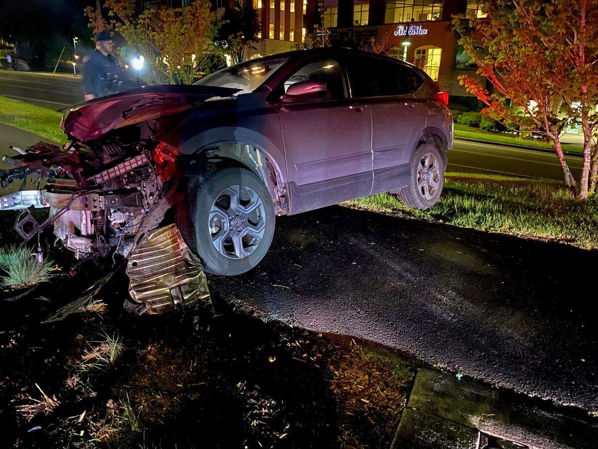 A woman faces charges after she lost control of her car and crashed into a Gig Harbor restroom building on Tuesday.