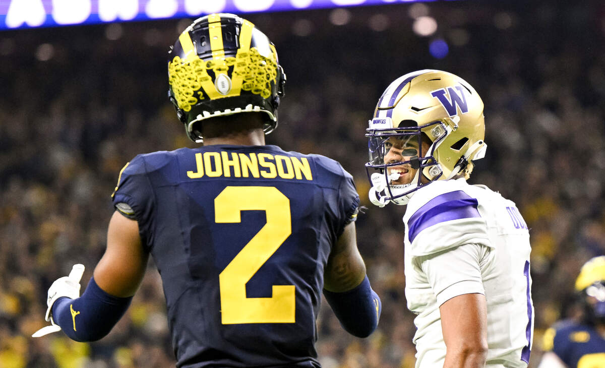 Washington Huskies wide receiver Rome Odunze (1) reacts a to pass interference call on Michigan Wolverines defensive back Will Johnson (2) that is offset by an offensive penalty during the fourth quarter of the College Football Playoff National Championship game at NRG Stadium on Monday, Jan. 8, 2024, in Houston.