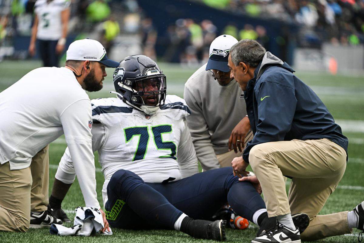 Seattle Seahawks guard Anthony Bradford (75) sits on the ground injured during the third quarter of the game against the Carolina Panthers at Lumen Field, Sunday, Sept. 24, 2023, Seattle, Wash.