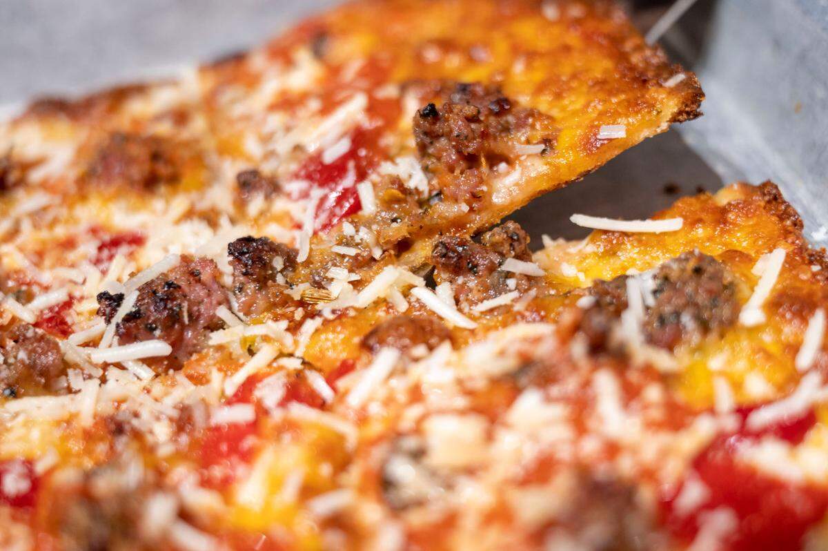 The thin-crust bar pizza at E9 Firehouse & Gastropub in Tacoma, Wash., is cooked in a blue steel pan with tomato oil, which yields both a crisp and chewy texture.