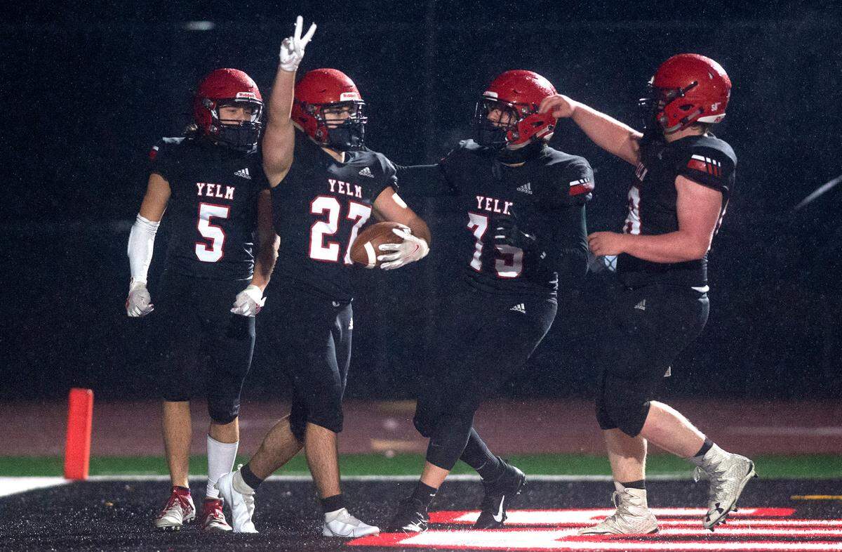 Yelm running back Sean Rowedder (27) celebrates with teammates following his second touchdown of the night during Friday nightÕs football game against the Olympia Bears at Yelm High School on Friday, Feb. 19, 2021.