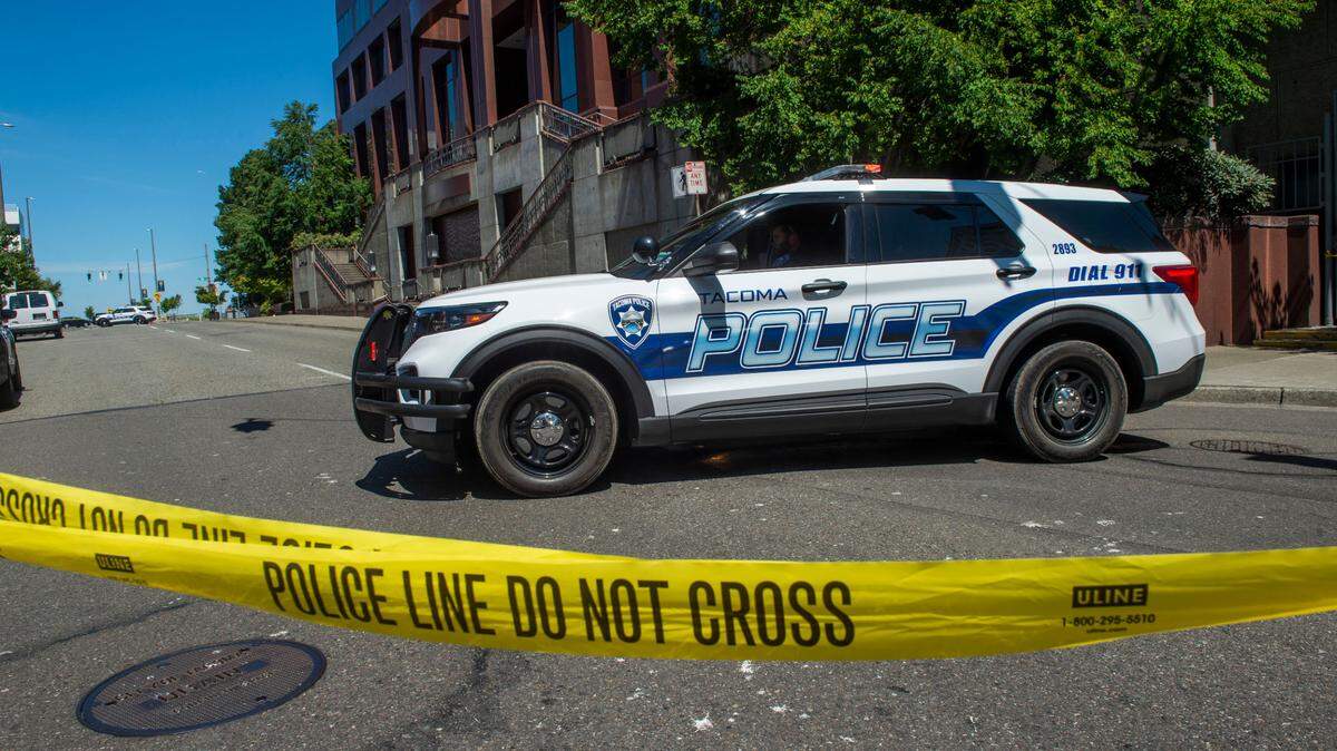 Tacoma police investigate the scene where a female security guard was found unconscious at 6 a.m., July 18, 2021 and later died. Police have new initiatives to address violent crime.