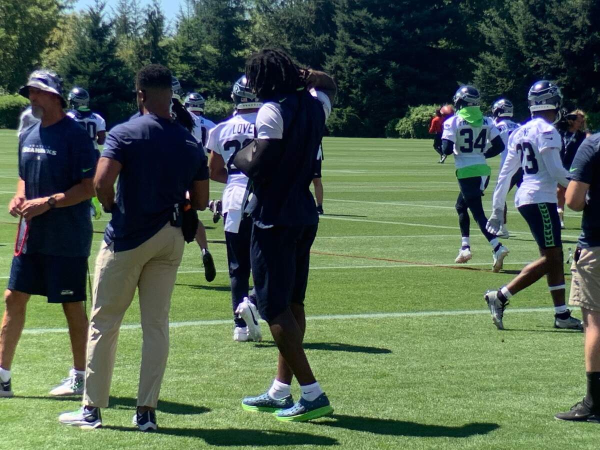 Linebacker Darrell Taylor, the Seahawks’ co-leader in sacks with 9 1/2 last season, watches the seventh practice of training camp Aug. 3, 2023, wearing a sling over his left arm and sprained shoulder.