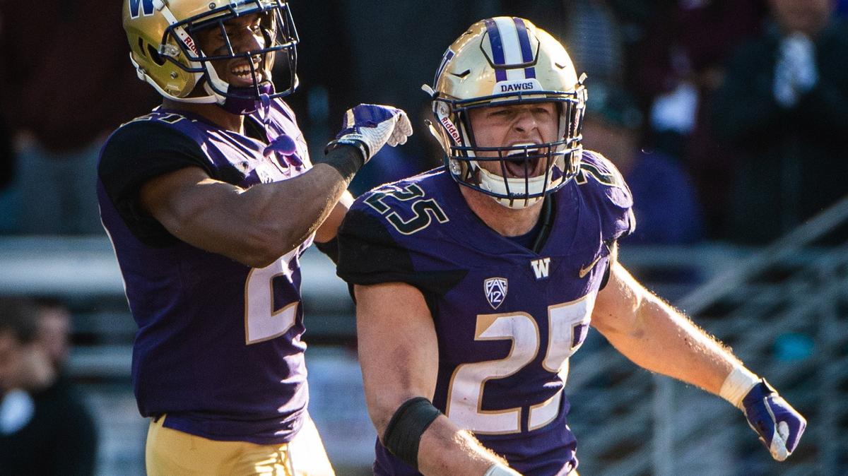 Washington defensive back Keith Taylor (27) and Washington linebacker Ben Burr-Kirven (25) celebrate Burr-Kirven’s interception in the fourth quarter put the game away. The Washington Huskies played the Colorado Buffaloes in a NCAA football game at Husky Stadium in Seattle, Wash., on Saturday, Oct. 20, 2018. 

