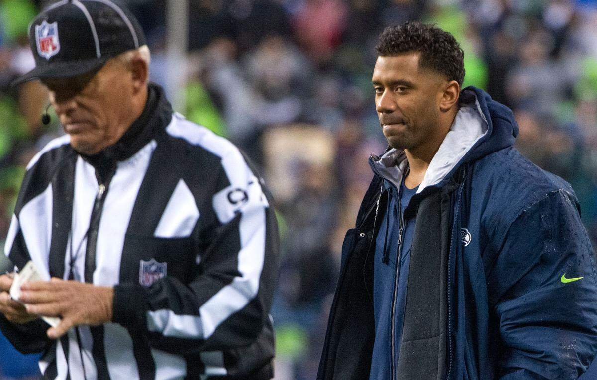 Seahawks quarterback Russell Wilson stifles a grin after sharing an opinion with an official during an NFL game between the Seattle Seahawks and the New Orleans Saints at Lumen Field in Seattle on Monday, Oct. 25, 2021.