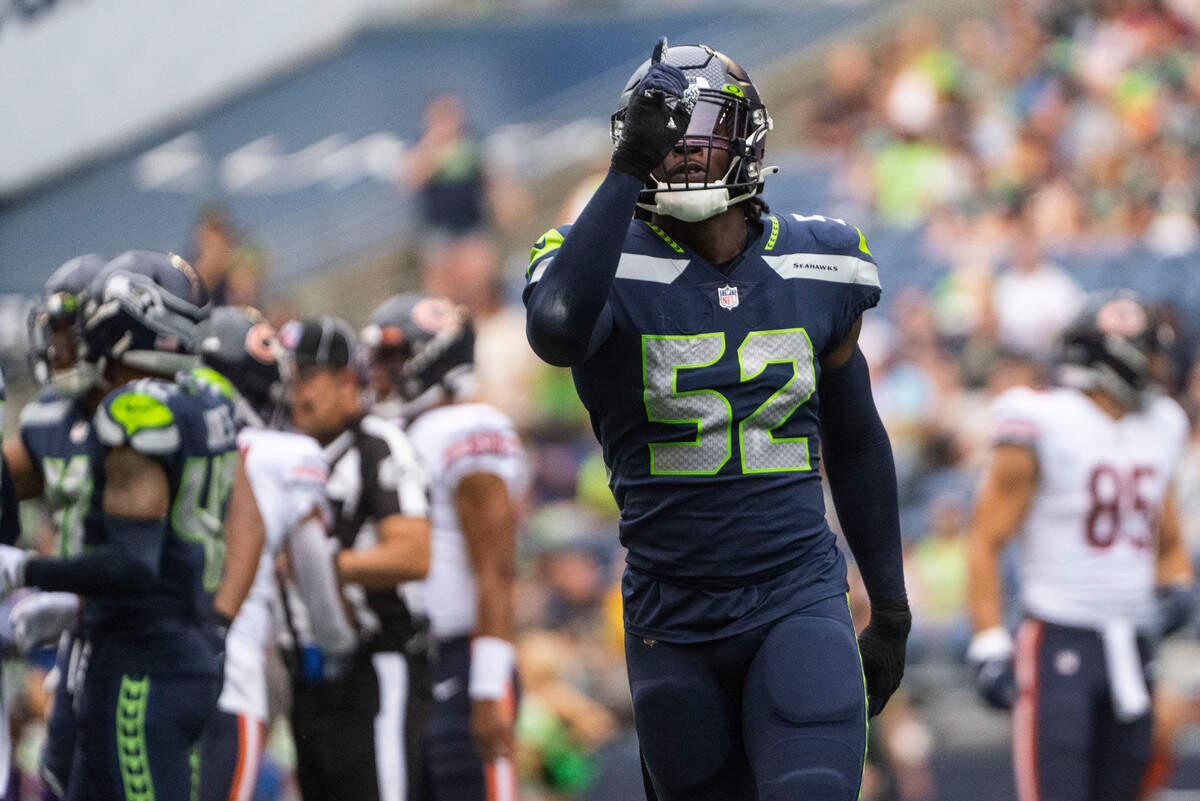 Seattle Seahawks defensive end Darrell Taylor (52) points to the sky after a play during the first half of the Seahawks second preseason game at Lumen Field in Seattle, Wash. on August 18, 2022.
