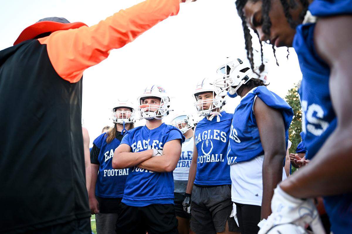 Graham-Kapowsin head coach Jeff Logan talks to players during a football practice at Graham-Kapowsin High School, Wednesday, Aug. 16, 2023, in Graham, Wash.