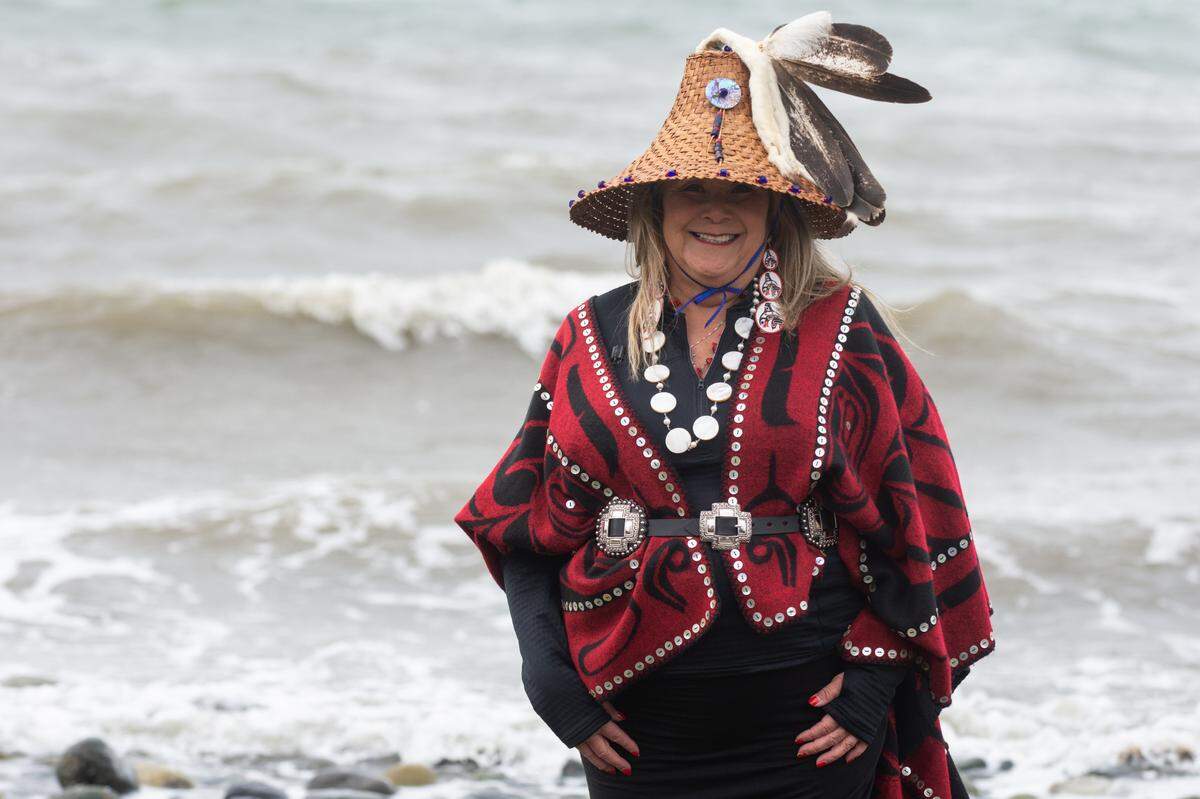 Raynell Morris, an enrolled Lummi Tribal member and vice president of the Sacred Lands Conservancy, stands in her regalia at a community prayer to bring home southern resident orca Sk’aliCh’elh-tenaut from the Miami Seaquarium March 20, at the sacred site of Cherry Point in Whatcom County. Squil-le-he-le (her traditional name), enjoys bringing her grandchildren and praying on the rocky beach.