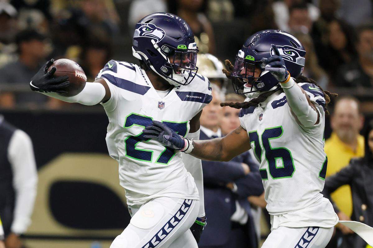 Seattle Seahawks’ Tariq Woolen celebrates with Ryan Neal, Woolen’s interception of New Orleans Saints quarterback Andy Dalton’s pass during an NFL football game in New Orleans, Sunday, Oct. 9, 2022. (AP Photo/Derick Hingle)