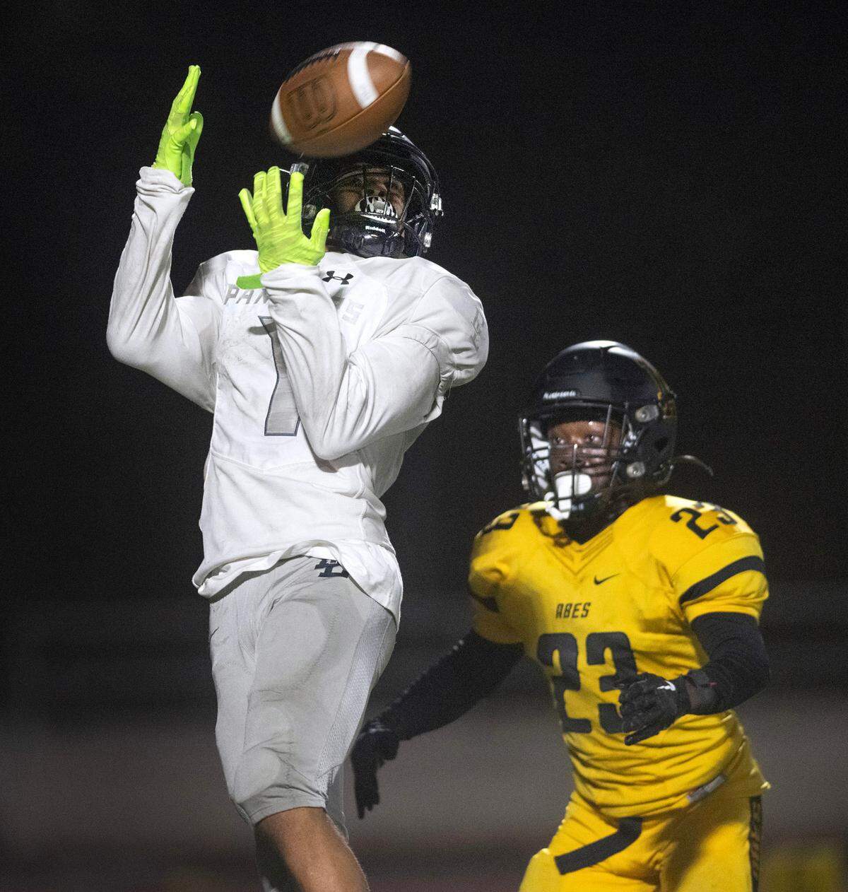 Bonney Lake wide receiver Marcus Lloyd pulls in a pass over Lincoln defensive back Immanuel Jordan during Thursday night’s football game at Lincoln Bowl in Tacoma, Washington, on Sept. 28, 2023. Lincoln won the game, 42-28.