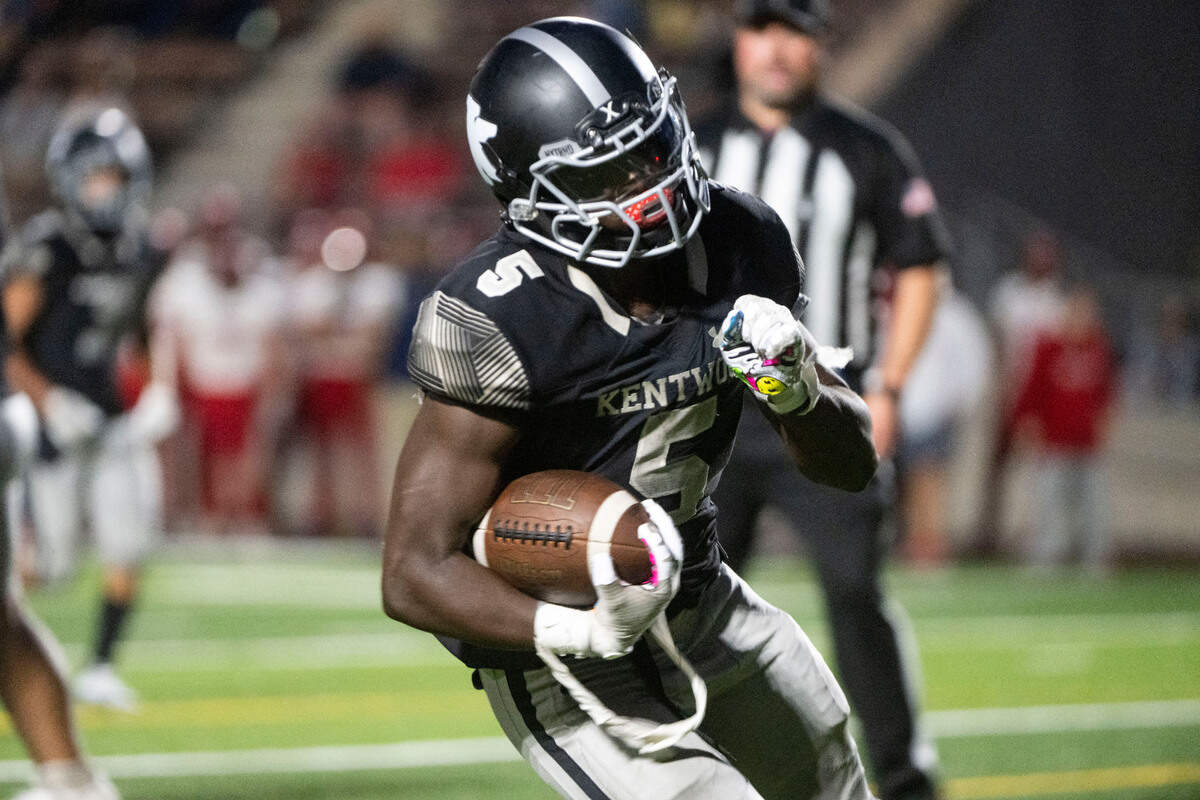 Kentwood running back Antoine Lee jogs in for a touchdown in the third quarter of a 4A NPSL game against Kennedy Catholic on Thursday, Sept. 15, 2022, at French Field in Kent, Wash.