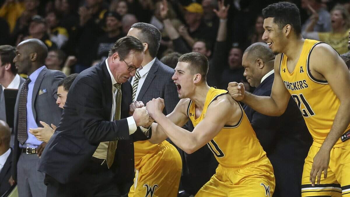 Wichita State head coach Gregg Marshall and guard Erik Stevenson celebrate on the sidelines in the final minute of their win over UCF at Koch Arena on Wednesday.