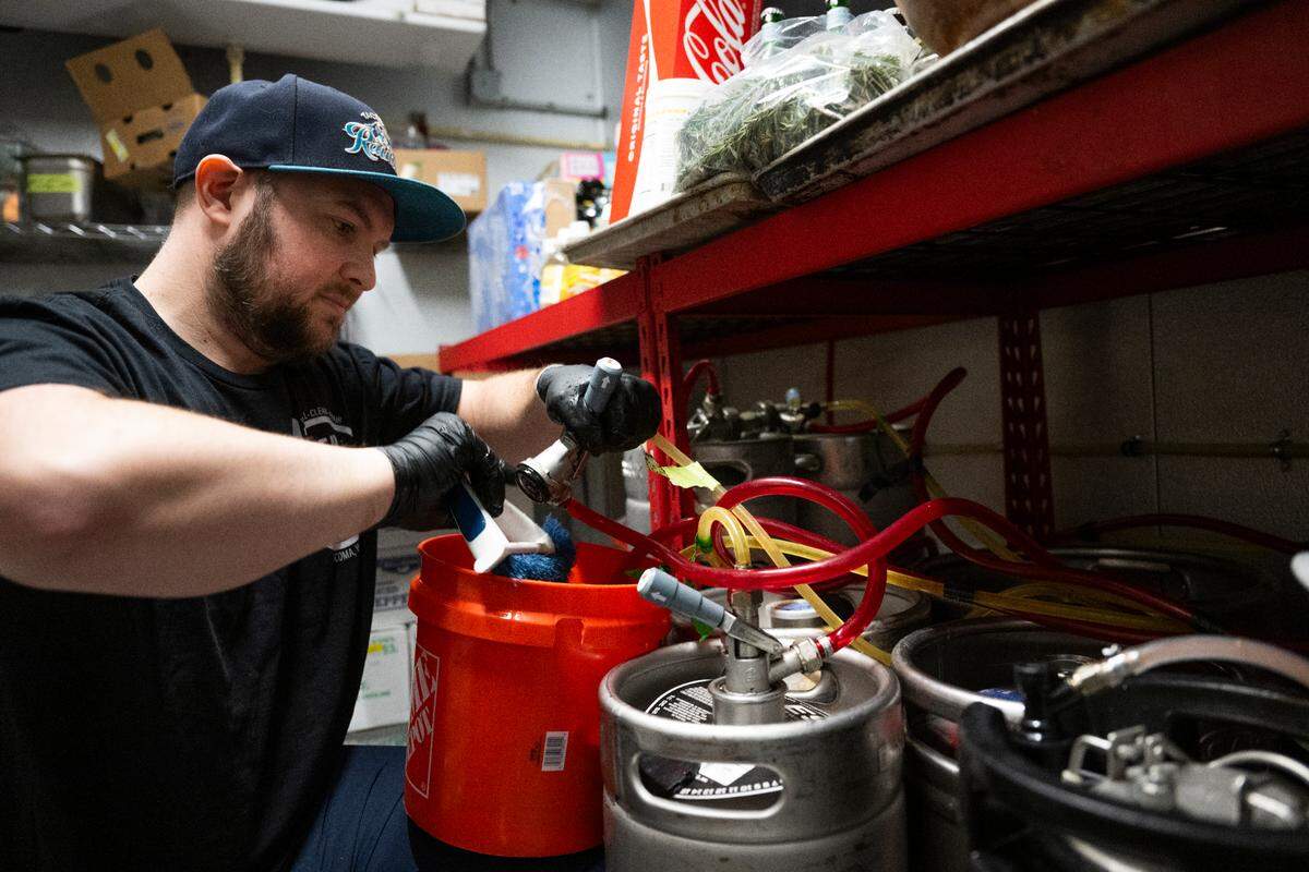 Jeromy Krom, owner of Clear Line Draft, cleans the draft lines at Bar Rosa, on Wednesday, Feb. 19. The system here is a short-draw, meaning the beer travels a brief distance from keg to faucet.
