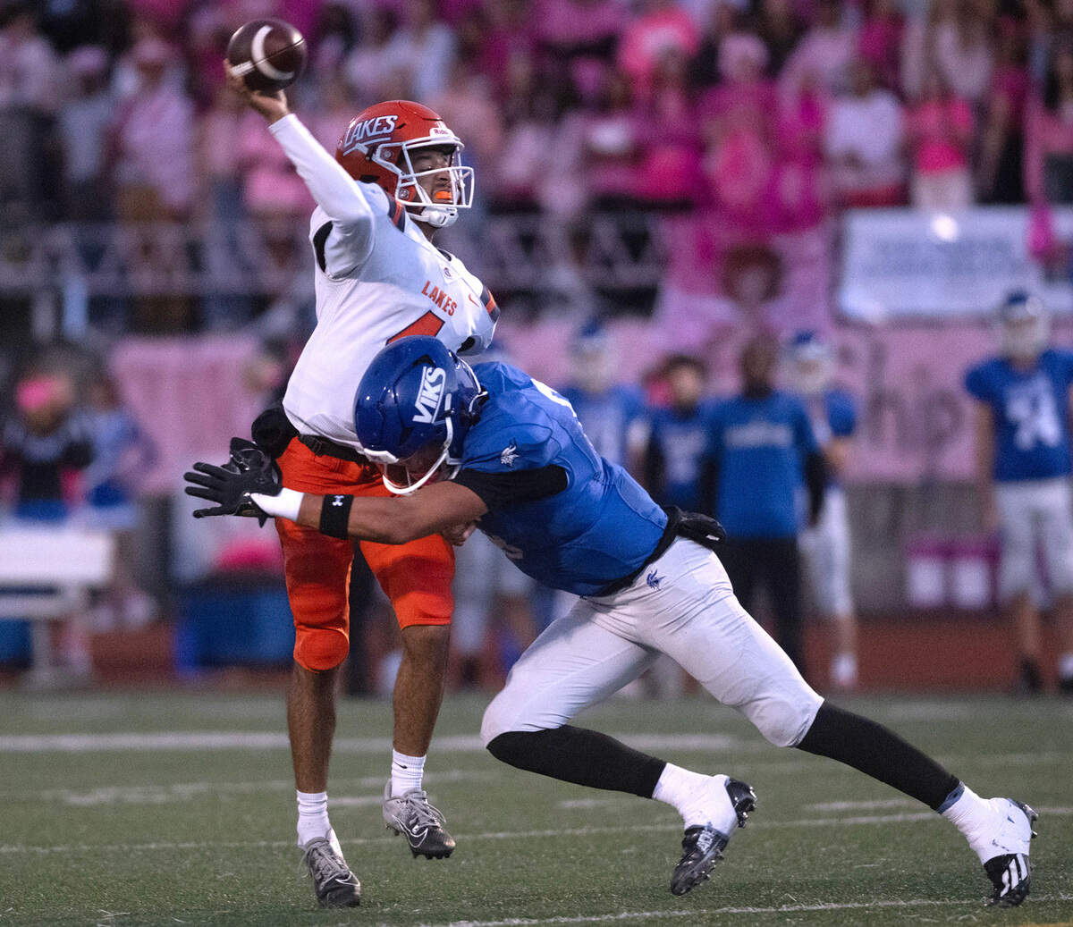 Lakes quarterback Willie Nash Jr. and Curtis’ Xavier Ahrens during a football game at Viking Stadium in University Place, on Sept. 20, 2024. After trailing 10-0, Lakes won the game, 14-10.