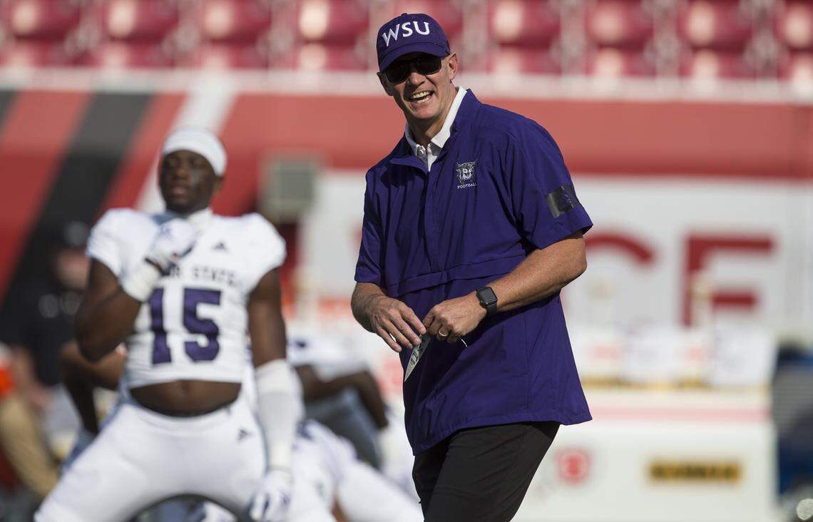 SALT LAKE CITY, UT - SEPTEMBER 2: Head coach Jay Hill of the Weber State Wildcats laughs during warmups before a game against the Utah Utes September 2, 2021 at Rice-Eccles Stadium in Salt Lake City, Utah. (Photo by Chris Gardner/Getty Images)