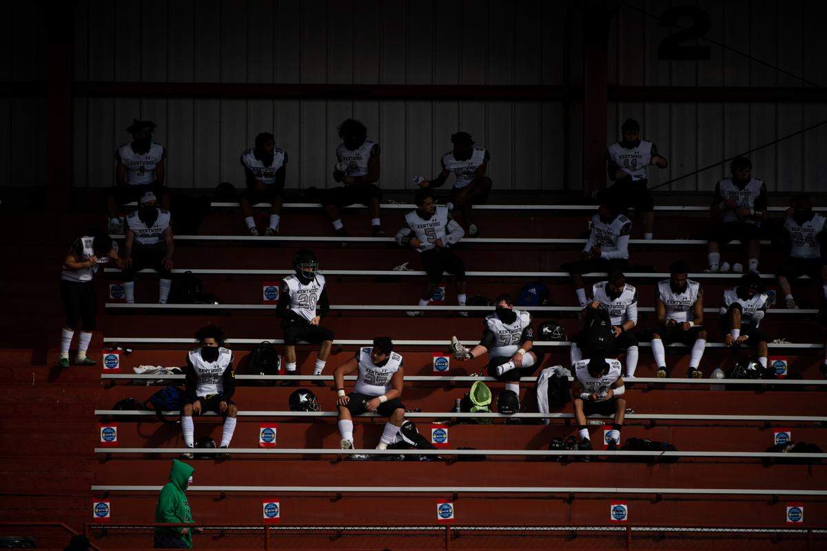 Kentwood players sit in the stands after the game. Federal Way played Kentwood in a football game at Federal Way High School in Federal Way, Wash., on Saturday, March 20, 2021.