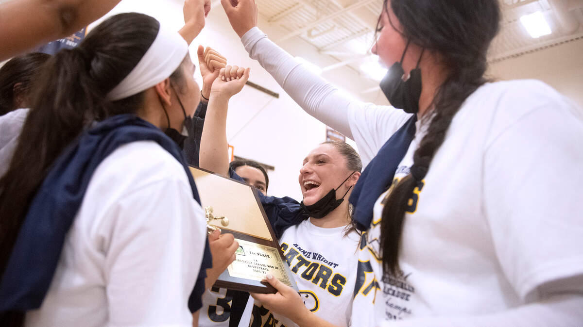 Annie Wright senior Julianna Walker celebrates with teammate following the Gators’ 82-35 victory over Cascade Christian in the 1A Nisqually league’s title game at Annie Wright High School in Tacoma, Washington, on Friday, June 18, 2021.