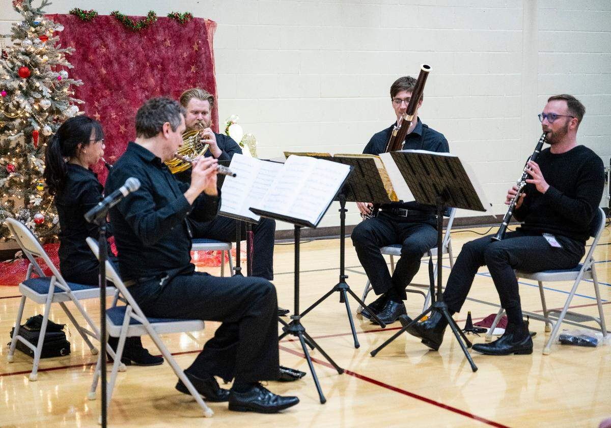 From left, Seattle Symphony members Jeffery Barker, Winnie Lai, John Turman, Kirpas Mazeika and Eric Jacobs perform live for inmates at the Washington Corrections Center for Women in the center’s gymnasium near Gig Harbor, Wash. on Dec. 6, 2022.