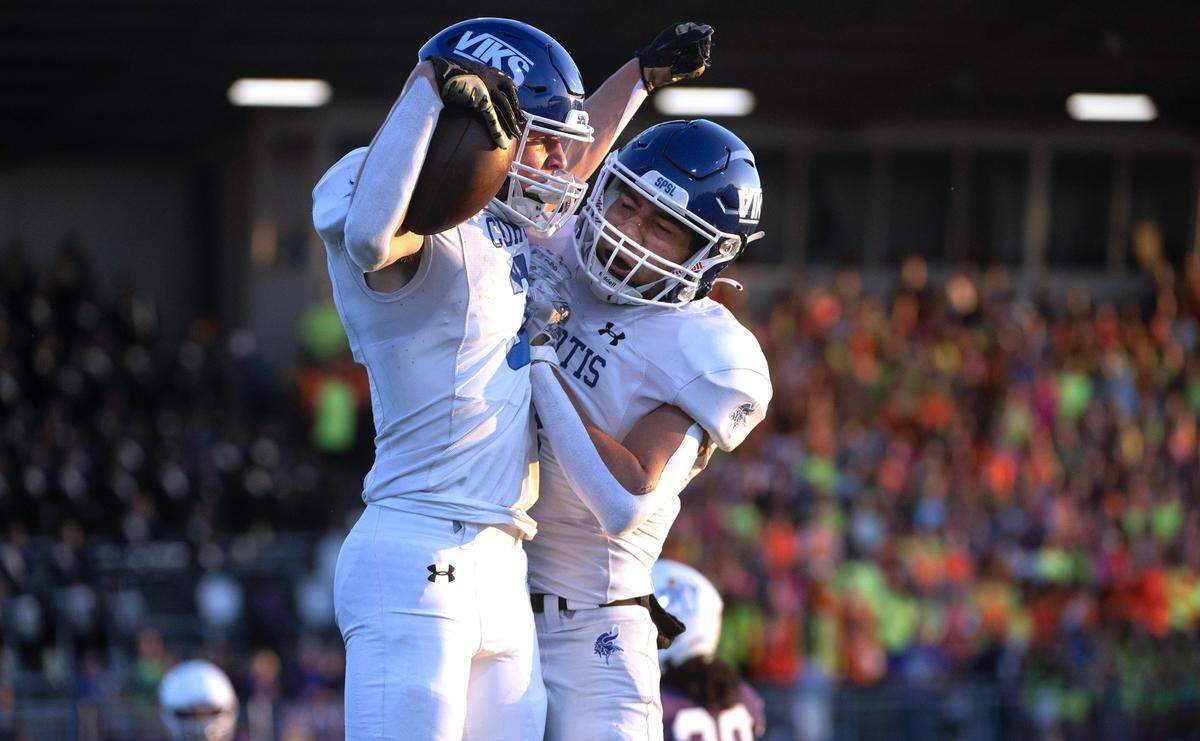 Curtis wide receiver Parker Mady (left) celebrates his touchdown catch with teammate Xavier Ahrens during Friday night’s football game against the Sumner Spartans at Sunset Chevy Stadium in Sumner, Washington, on Sept. 8, 2023. Curtis won the game, 38-33.