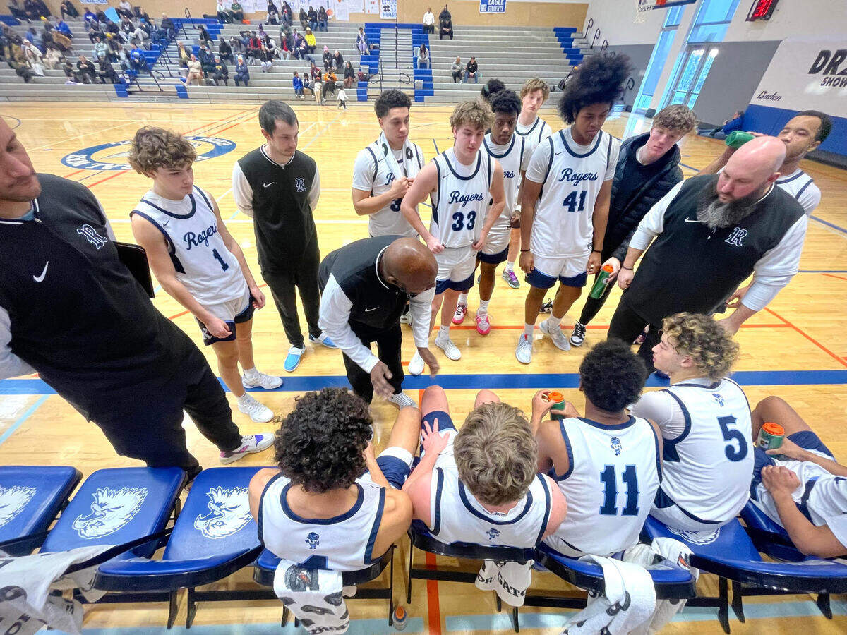 The Rogers Rams basketball team huddles during a timeout at The Dream Showcase basketball tournament at Federal Way High School on Monday, Jan. 20, 2025.
