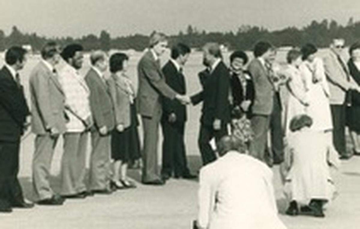 President Jimmy Carter meets a line of Democratic party leaders, candidates and dignitaries upon his arrival via Air Force One at McChord Air Force Base on Sept. 23, 1980.