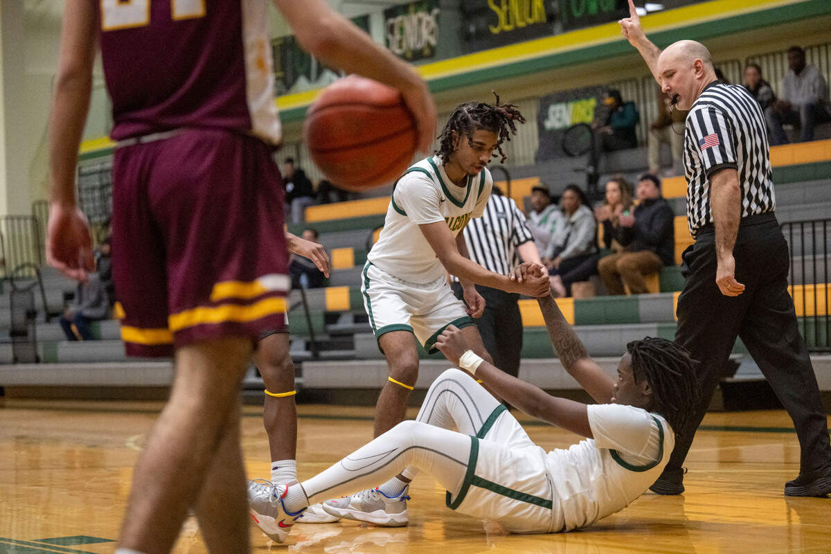Foss’s Jamie Killian-Howard helps up Nathaniel Campbell after he was fouled after making a basket during the third quarter of 2A SPSL game against Enumclaw on Tuesday, Jan. 24, 2023, in Tacoma, Wash.