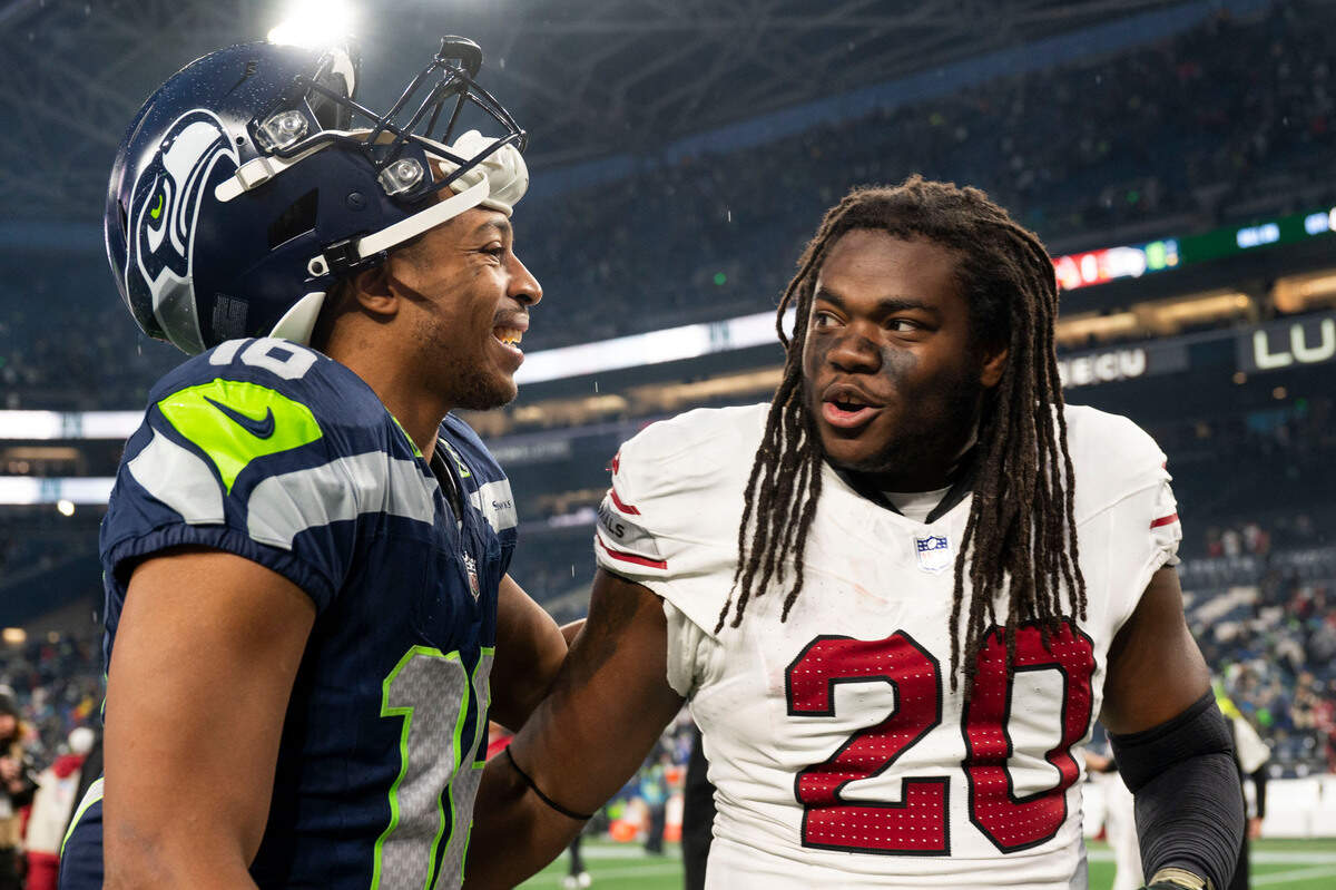 Seattle Seahawks wide receiver Tyler Lockett (16) and former teammate Arizona Cardinals running back DeeJay Dallas (20) talk after the Seattle Seahawks’ 16-6 victory against the Arizona Cardinals at Lumen Field, on Sunday, Nov. 24, 2024, in Seattle, Wash.