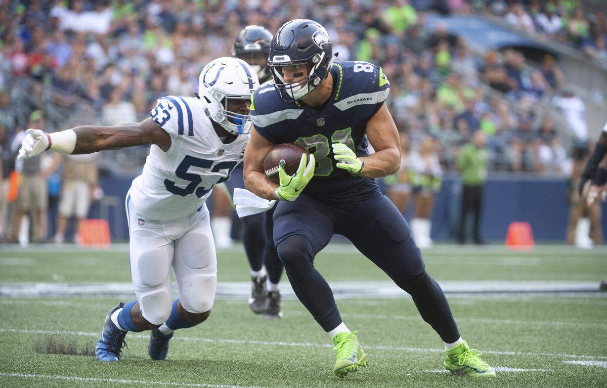 Seahawks tight end Nick Vannett pulls in a pass reception in front of Colts linebacker Darius Leonard during Thursday night’s NFL preseason game at CenturyLink Field in Seattle on Aug. 9, 2018.