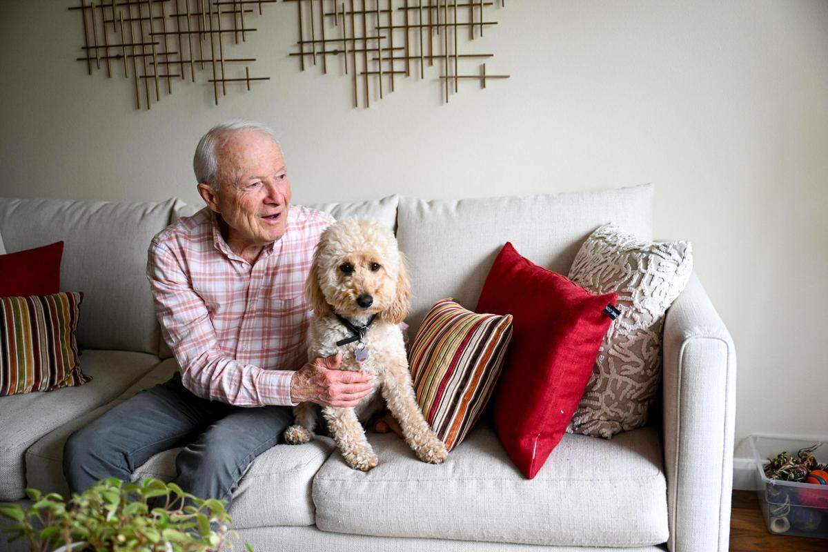 Dave Pine, 88, and Scooter at home, Wednesday, Aug. 9, 2023, in Gig Harbor, Wash. Pine recently finished a seven-day trek through the Cascades and walks Scooter every day to try to stay active.
