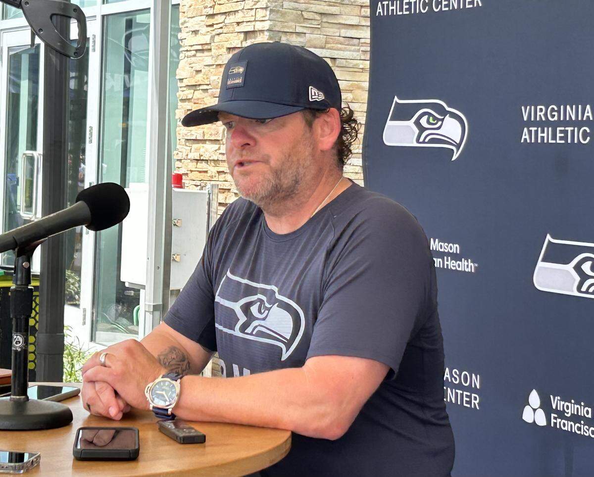 John Schneider speaks at the Virginia Mason Athletic Center following the seventh practice of Seahawks training camp July 30, 2025. He talked hours after he signed a four-year contract extension from team chair Jody Allen to remain the team’s general manager and president of football operations through the 2030 NFL season.